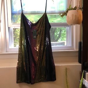 A short sequined slip-style mini dress with a dark rainbow gradient effect